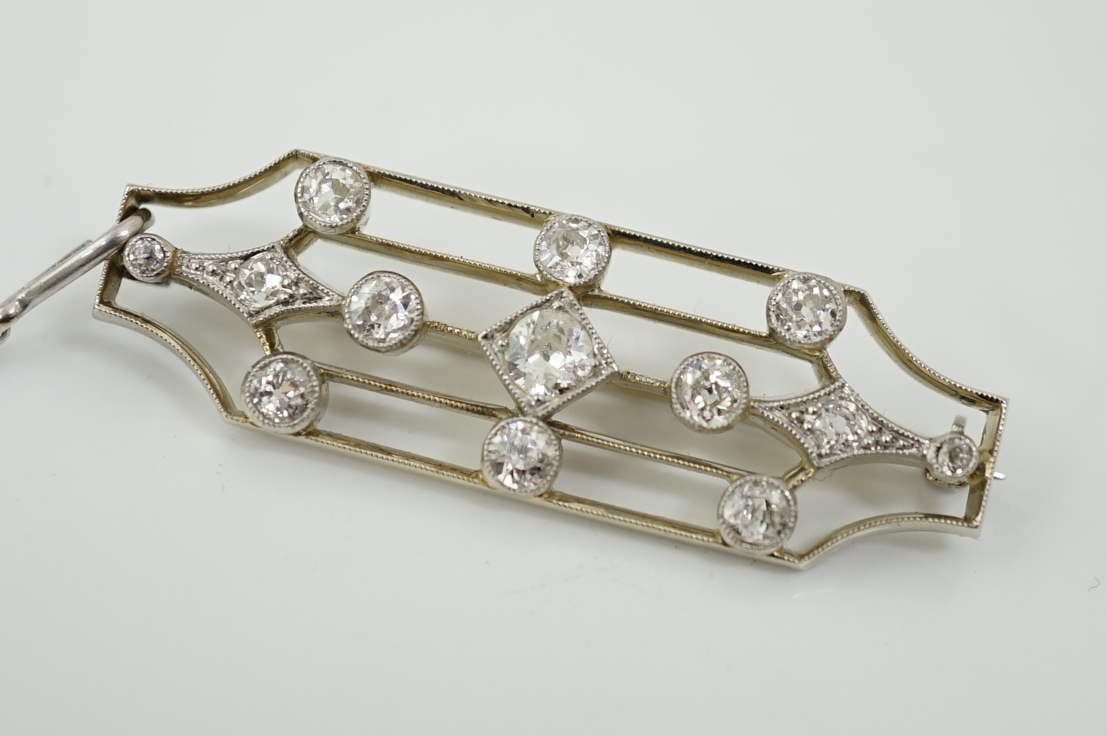 An early 20th century 18ct white gold, platinum and millegrain set diamond cluster openwork brooch